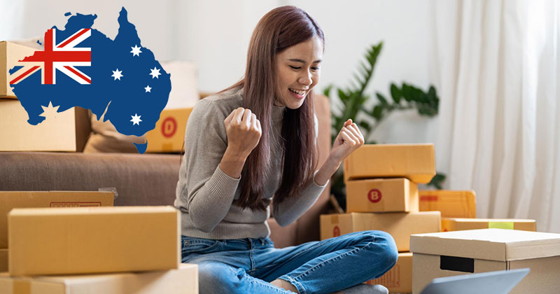dropshipping suppliers australia - Woman sat on floor surrounded by boxes smiling